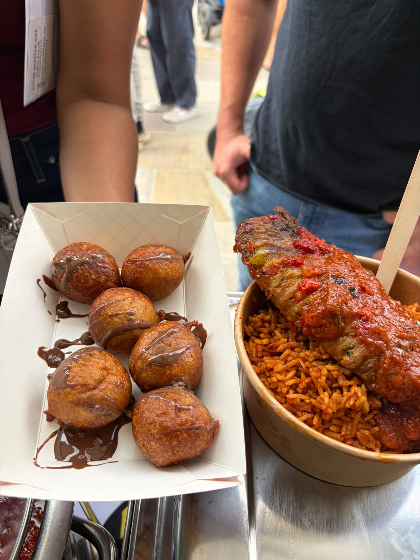 Event serving of puff-puff with chocolate drizzle and jollof rice with chicken