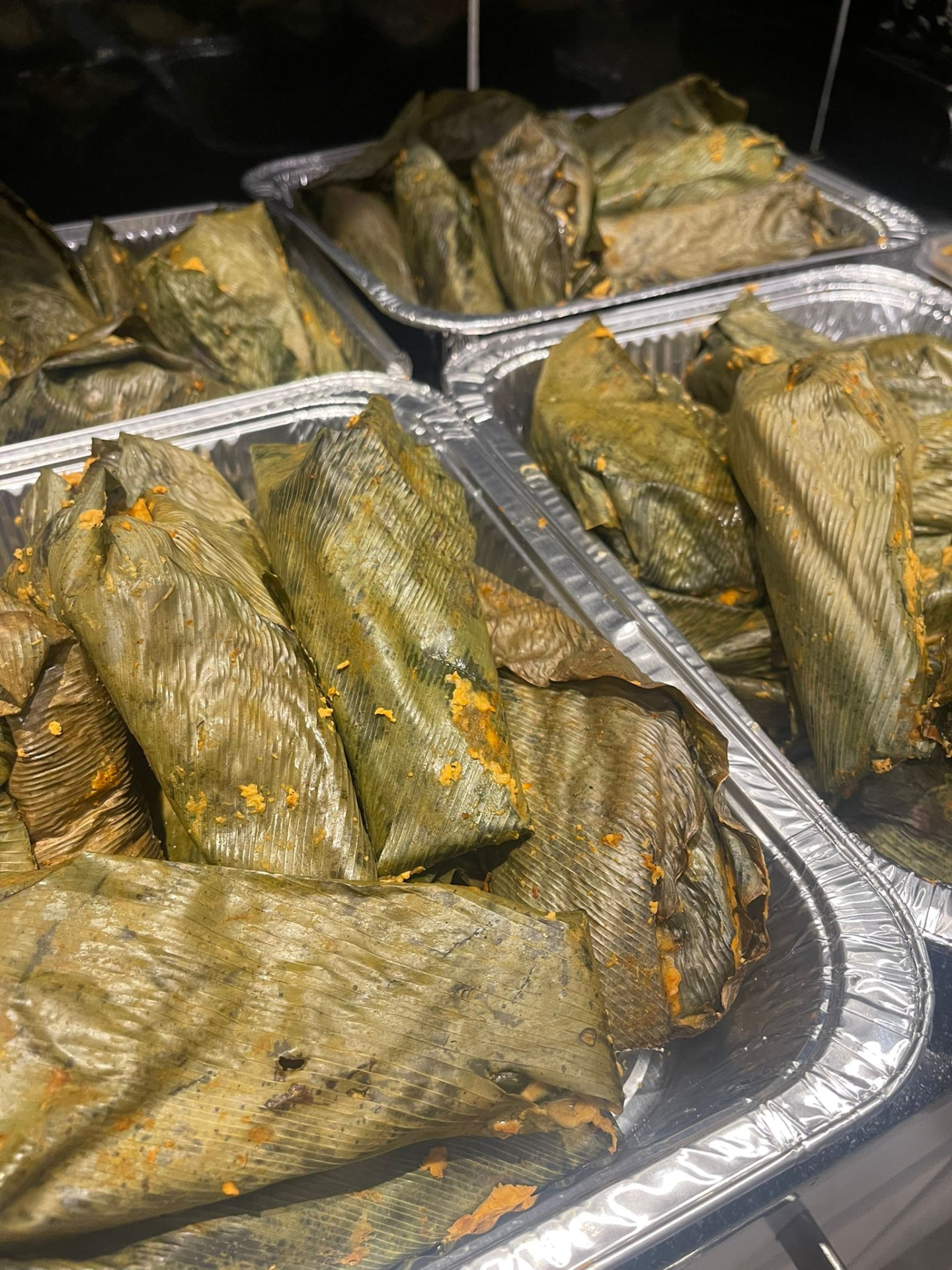 Trays of moin-moin bean pudding steamed in banana leaves