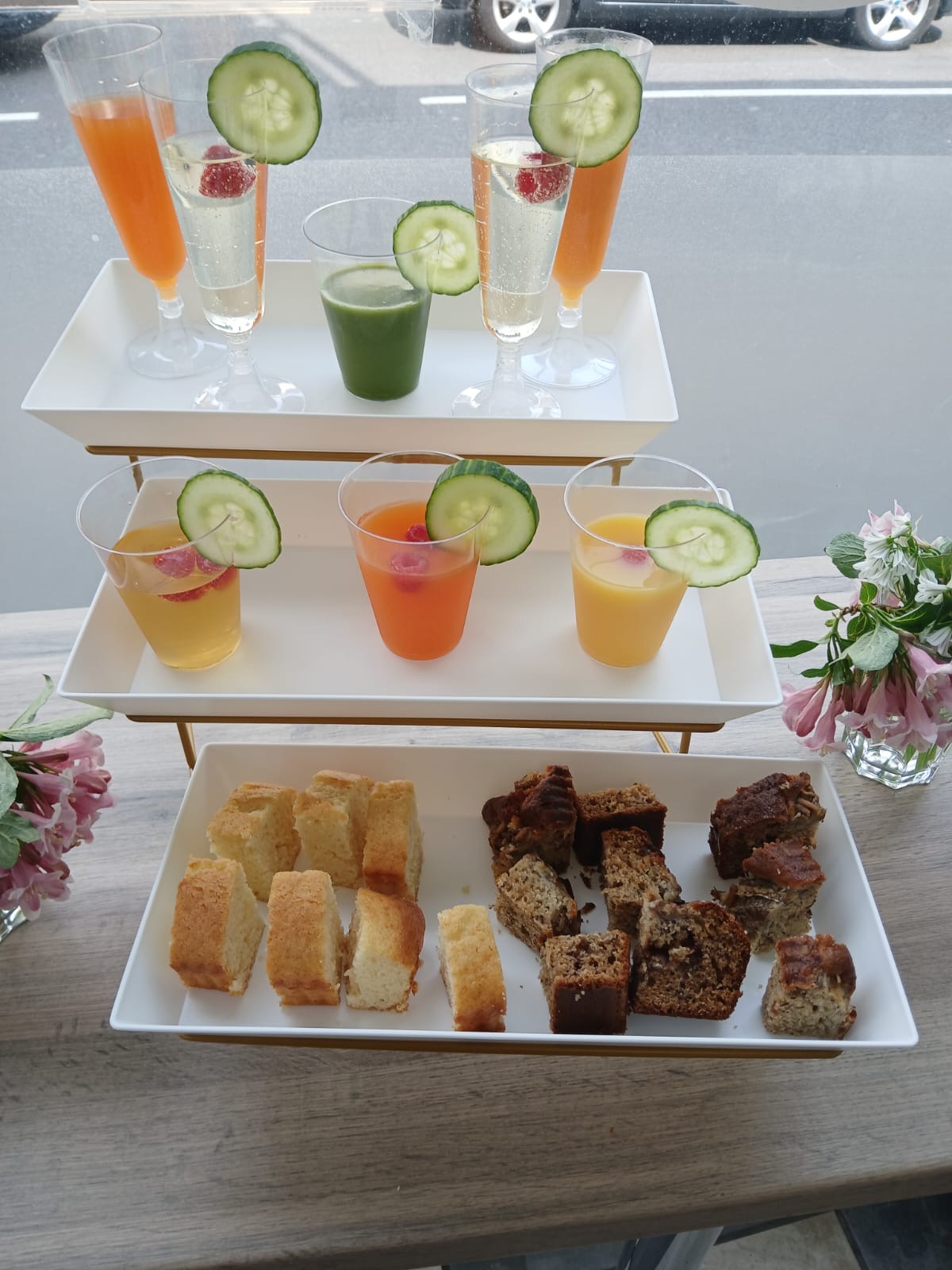 Refreshment display with fruit drinks, sparkling drinks and sliced cakes