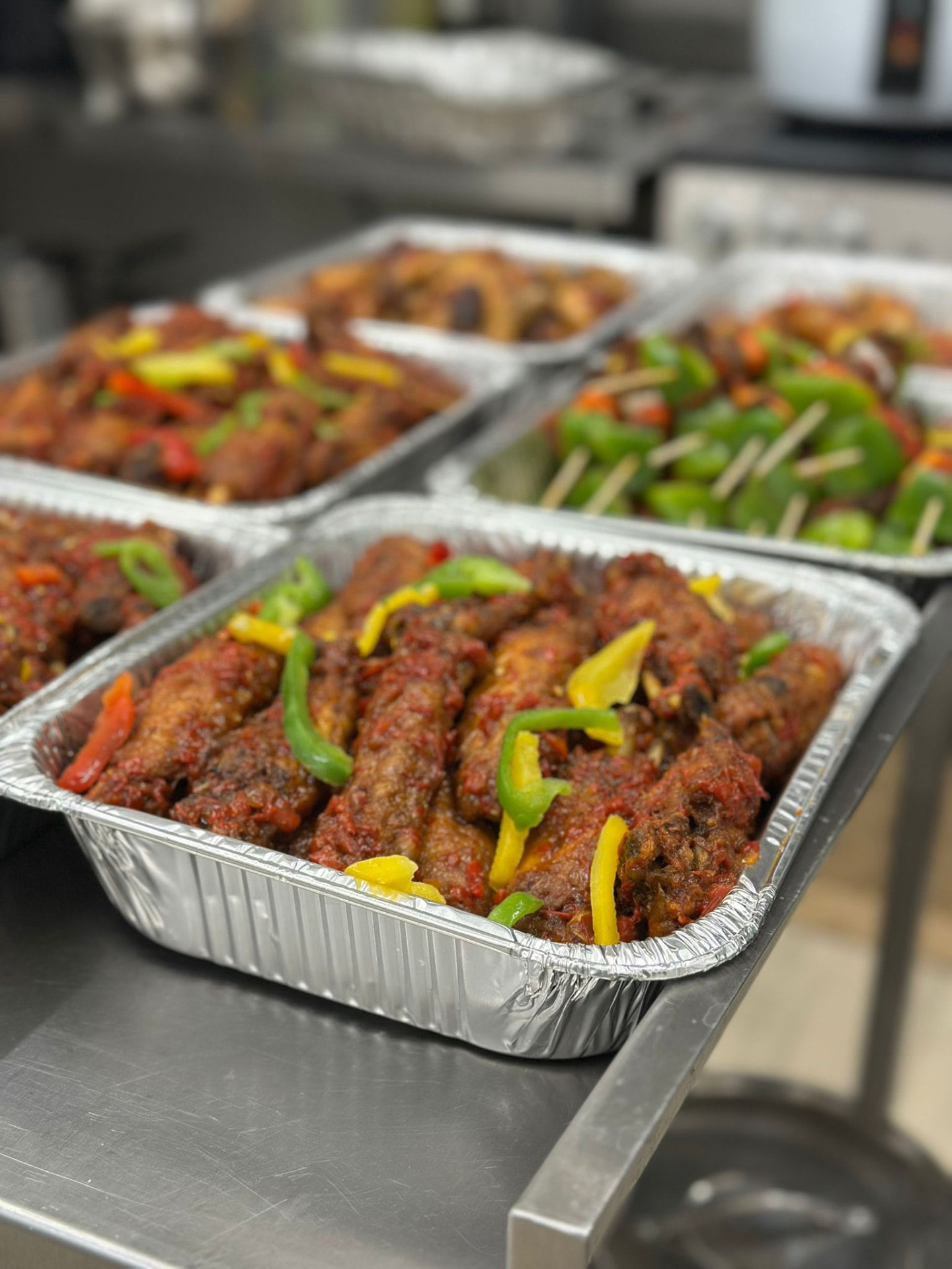 Catering trays of peppered fish and grilled skewers